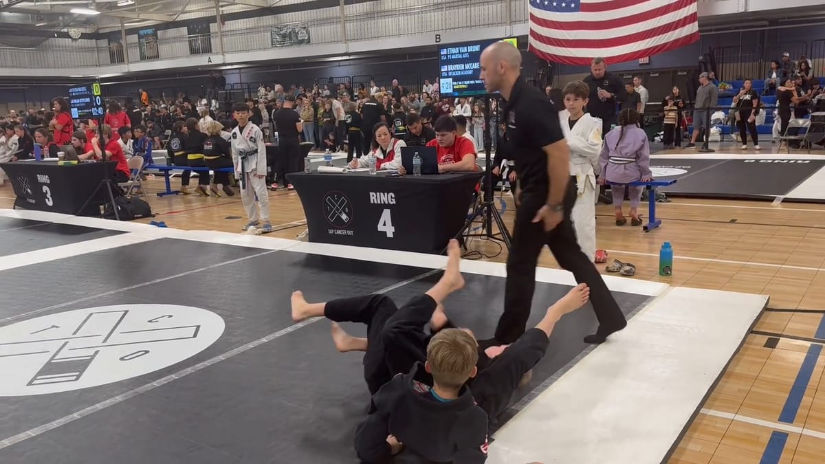 Ethan finishing his quarterfinal by submission on the Ring 4 mat