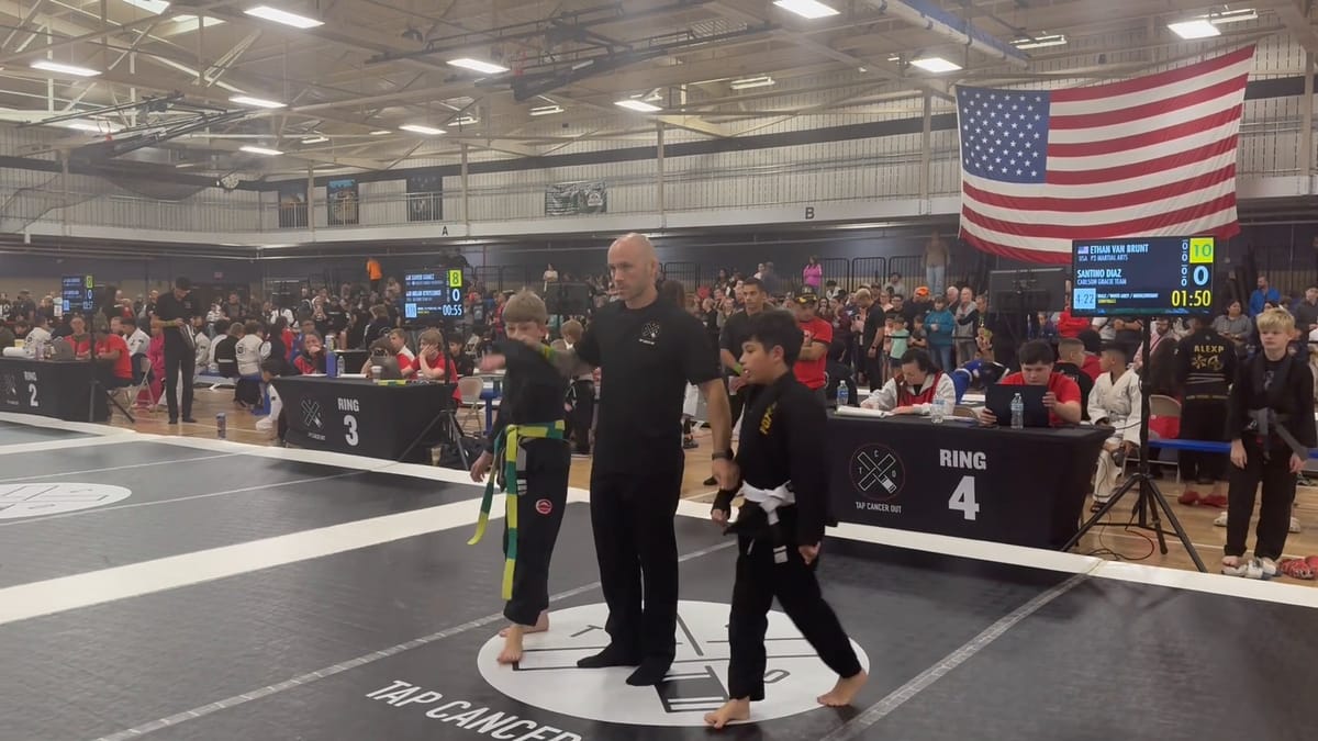 Ring 4 at the end of the semifinal, the referee standing over Ethan and his opponent